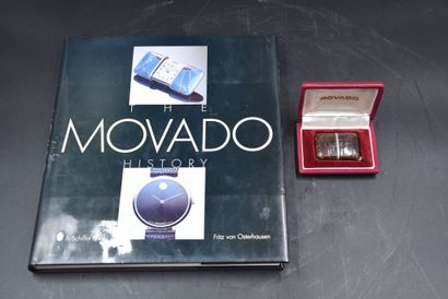 null Movado travel watch in its box. A book on the theme is attached. 

NL: Movado...