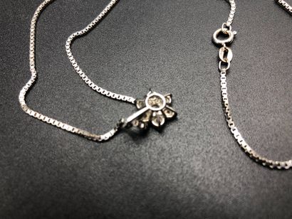 null White gold necklace and its small pendant decorated with 7 diamonds. Total weight:...