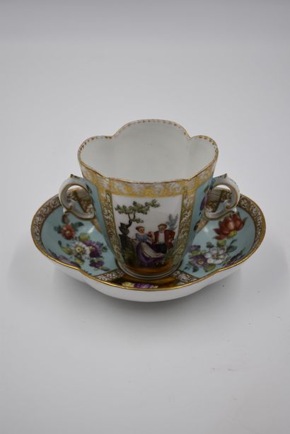 null Cup with two handles and its saucer decorated with floral and romantic subjects....