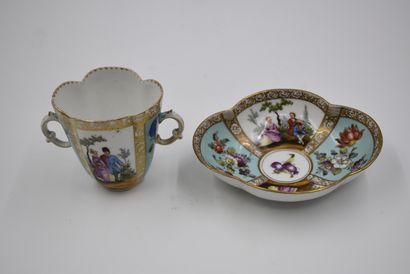 null Cup with two handles and its saucer decorated with floral and romantic subjects....