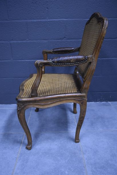 null Armchair from the Louis XV period in natural wood, seat and back in caning....
