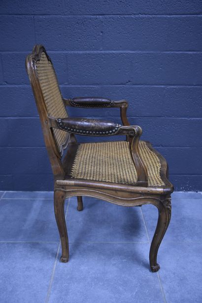 null Armchair from the Louis XV period in natural wood, seat and back in caning....