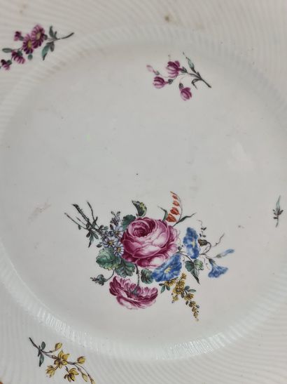 null Assiette en porcelaine de Tournai XVIIIème à décor polychrome de fleurs. Chantournée,...