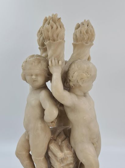 null Sculpture en albâtre représentant une ronde de trois putti adossés à des flambeaux....