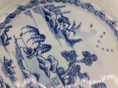 null Pair of white/blue Chinese porcelain plates decorated with landscapes and pagodas....