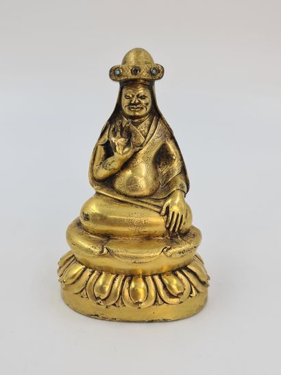 null 
Lama of the yellow bonnets sect. Gilded bronze. Tibet 19th century. Ht : 12...