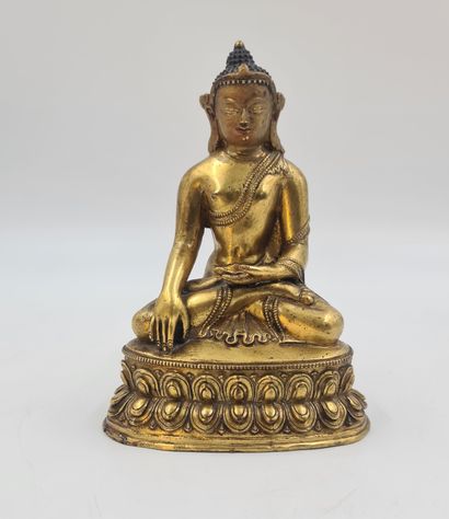 null 鎏金铜像，表现佛陀坐在莲花上，做出以大地为证的姿态，Bhamisparsa Mudra，西藏20世纪。高度：19厘米。

博爱达在莲花上的青铜盾牌，它...