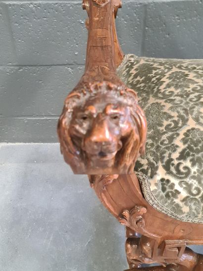 null Walnut stool carved on both sides with chimeras, a tiger's head and lions' heads....