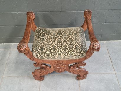 null Walnut stool carved on both sides with chimeras, a tiger's head and lions' heads....