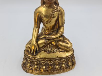 null 鎏金铜像，表现佛陀坐在莲花上，做出以大地为证的姿态，Bhamisparsa Mudra，西藏20世纪。高度：19厘米。

博爱达在莲花上的青铜盾牌，它...