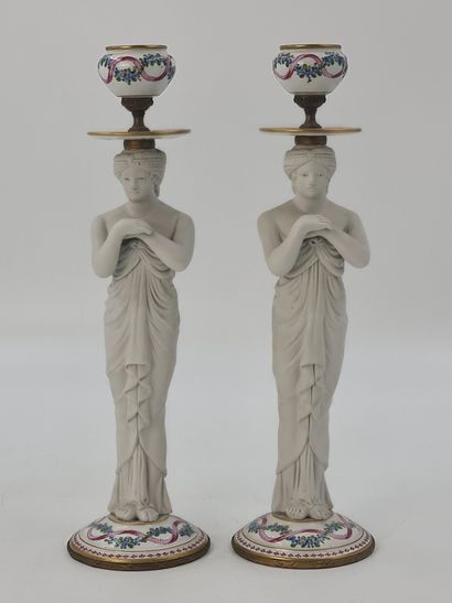 null Pair of porcelain and white cookie candlesticks representing oriental women...