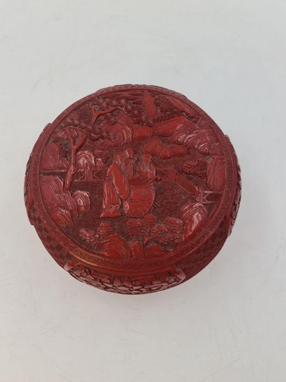 null Round covered box in cinnabar lacquer, central medallion decoration of sages...