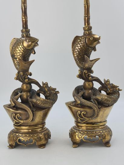 null Pair of large bronze candelabras representing a dragon and a carp supporting...