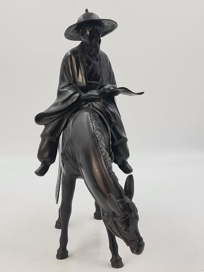 null Bronze subject with brown patina, representing Toba on his mule, wearing a large...