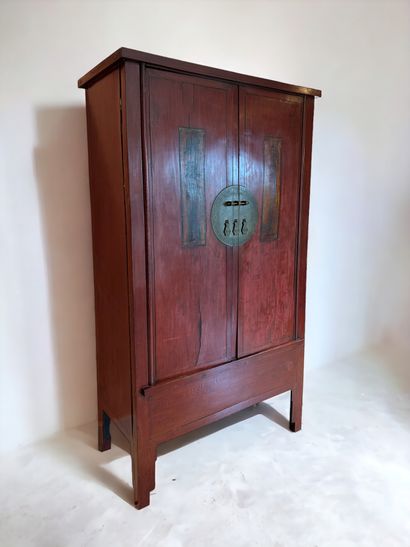 null China, early 20th century, circa 1900/1920. Red wood cabinet opening to two...