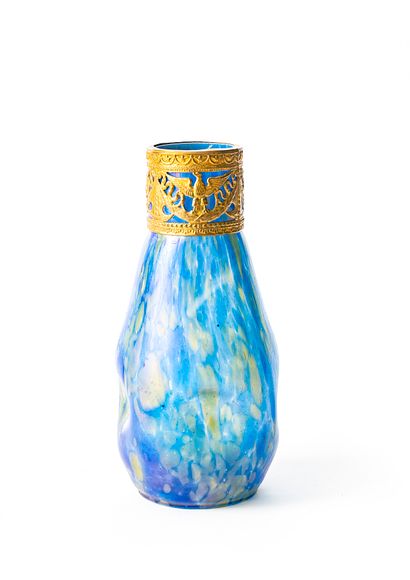 null Glass vase in bluish shades with iridescent spots, the body with four recesses,...
