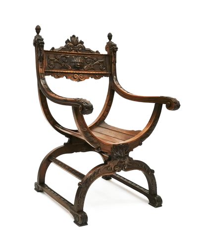 null Neo-Gothic style curule armchair in carved wood decorated with masks of chimeras,...