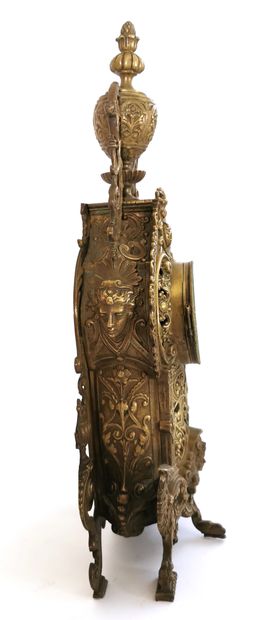 null Clock in chased bronze, gilt and brass with richly architectural decoration...