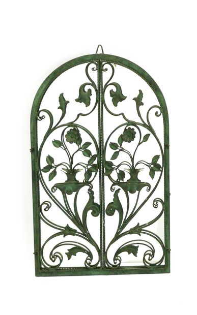 null Wrought iron wall-mounted mirror with green patina decorated with two openwork...