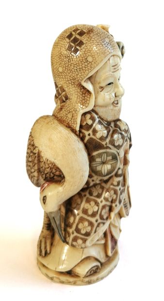 null *Japan, 1920

Carved polychrome ivory okimono with an old man leaning on his...