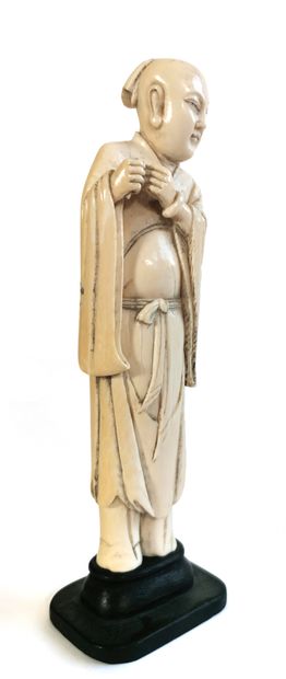 null *China, 1880

Carved ivory figure, possibly a luohan dressed in a long garment...