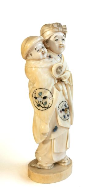 null *Japan, 1880

Carved ivory okimono featuring a figure carrying a child; both...
