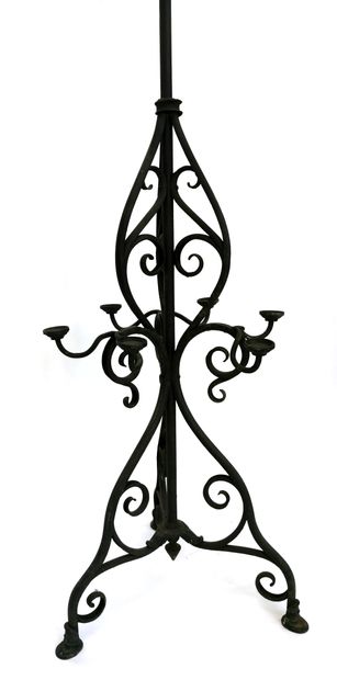 null *Wrought iron light holders with winding patterns and crosses; the upper crown...