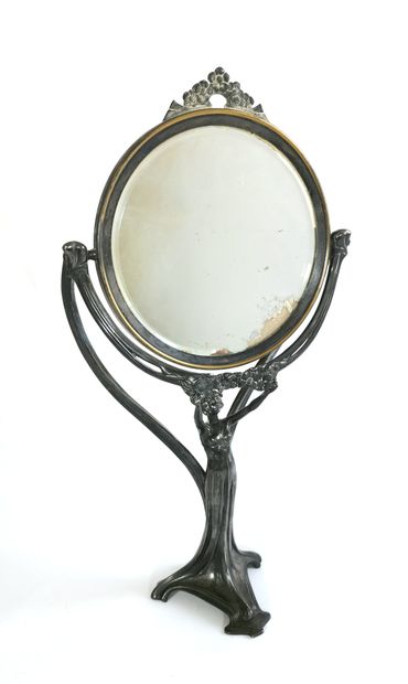 null Tripod toilet mirror in silver plated metal, the shaft showing a woman dressed...