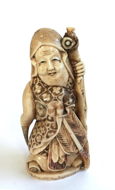 null *Japan, 1920

Carved polychrome ivory okimono with an old man leaning on his...