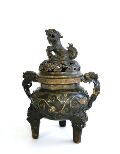 null CHINA

Bronze incense burner with tripod base

The lid surmounted by a dog of...