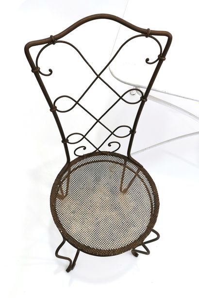 null Pair of wrought iron chairs with perforated seat and openwork back decorated...