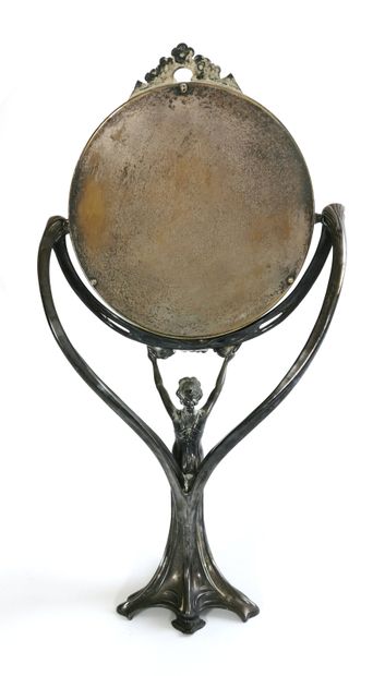 null Tripod mirror in silver plated metal, the shaft showing a woman dressed in the...