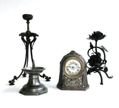 null Three candlesticks in metal, bronze and pewter

A silver plated clock with foliage...