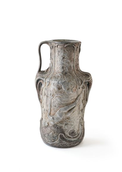 null Jean GARNIER (1853-1910)

A high pewter vase carved in bas-relief with two undines...