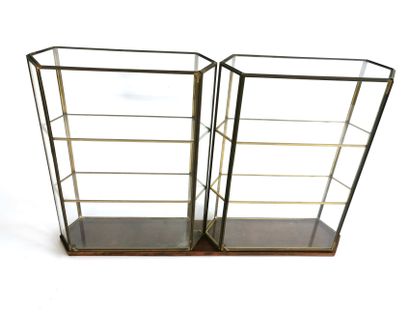 null A pair of hexagonal glass and brass display cases resting on a handcrafted natural...