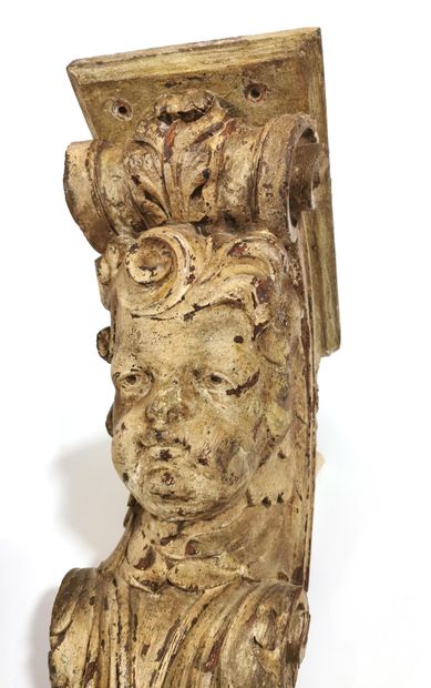 null A pair of carved and cream lacquered wood brackets in the form of cherubs' heads...
