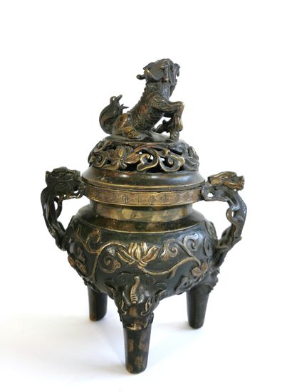 null CHINA

Bronze incense burner with tripod base

The lid surmounted by a dog of...