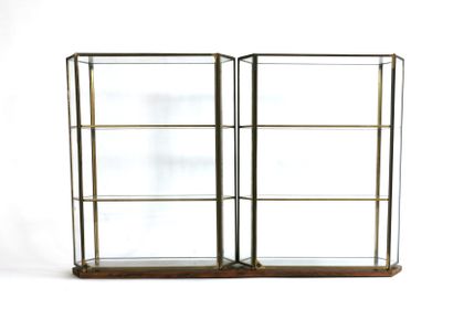 null A pair of hexagonal glass and brass display cases resting on a handcrafted natural...