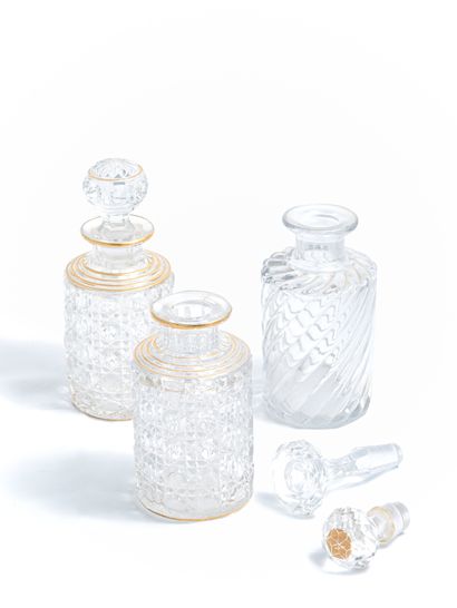 null Two perfume bottles in cut glass underlined by golden circles with their stoppers...