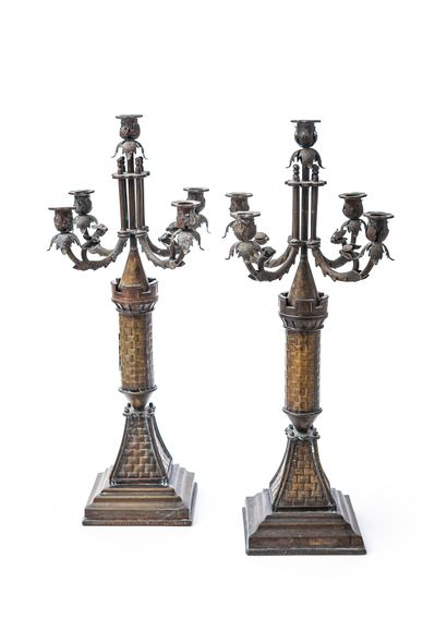 null A pair of five-light chased copper candelabra, the shaft depicting medieval...
