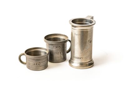 null Three pewter whisky measures with English graduations
