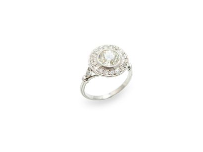 null A platinum ring with circular table set with a round old cut diamond weighing...