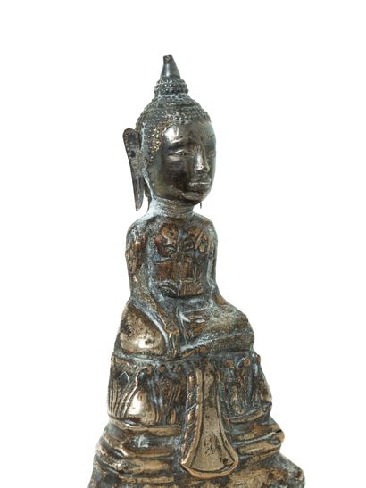 null Cambodia, 19th century 

A silver embossed Buddha figure, depicted seated in...