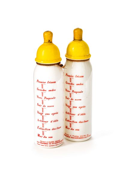 null Two opaline glass Armagnac advertising bottles in the shape of a baby's bottle...