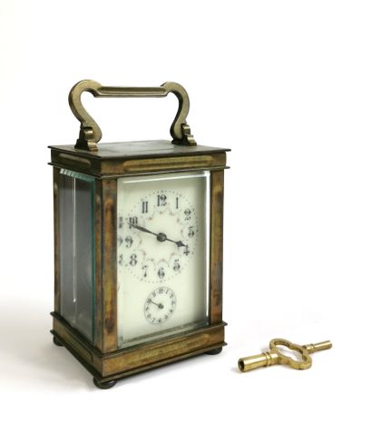 null Officer's clock, the brass cage and bevelled glasses surmounted by a handle,...