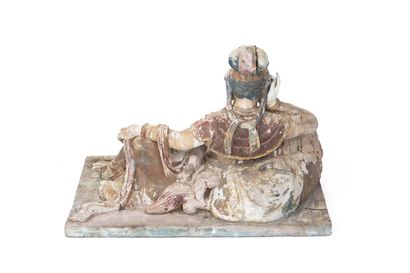 null China, 19th century 

Figure of Guanyin in carved wood, represented reclining...