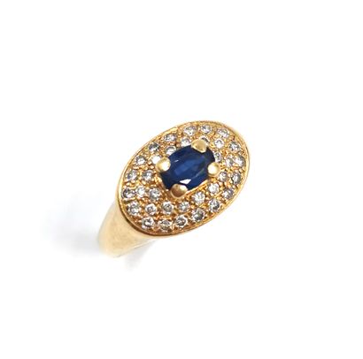 null Yellow gold ring 18K (750 thousandths) decorated with an oval faceted sapphire...