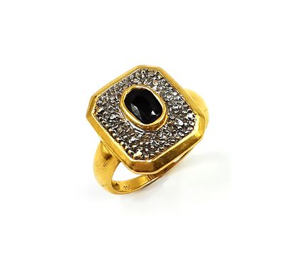 null Ring in gold two tones 18K (750 thousandths) decorated with a faceted oval sapphire...