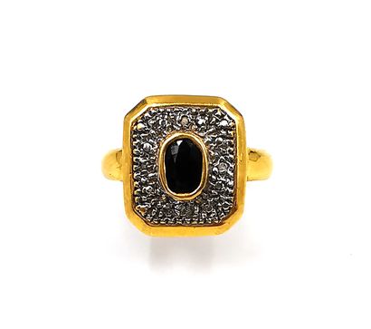 null Ring in gold two tones 18K (750 thousandths) decorated with a faceted oval sapphire...