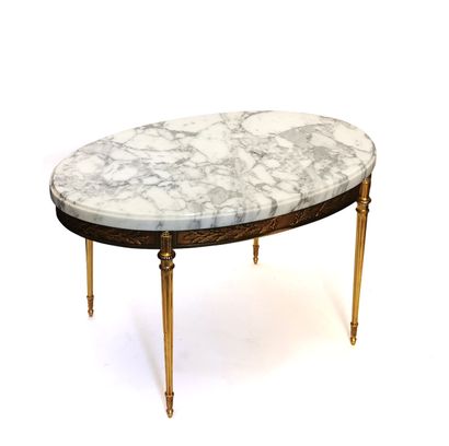 null A Louis XVI style chased bronze and gilt coffee table with marble top

H. 48...